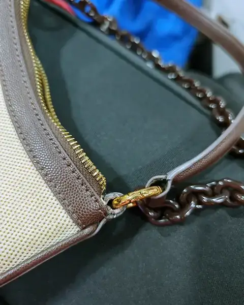 The same handbag with the chain strap reattached