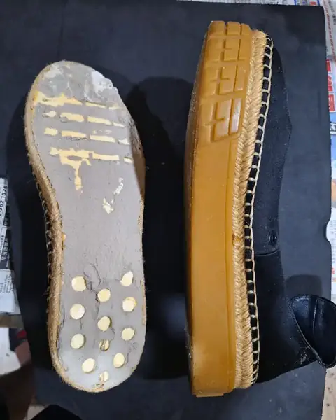 Espadrille with a worn rubber sole, before repair