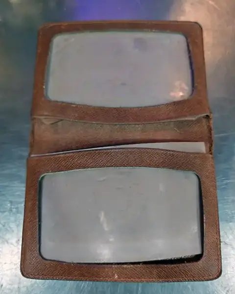 Leather card wallet with clouded, worn clear windows, before repair