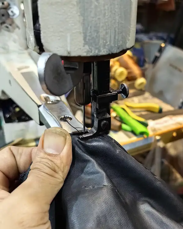 Leather being stitched on the machine at the KL Cobbler & Locksmith counter